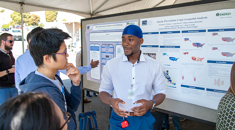 An intern explains his work to a guest.